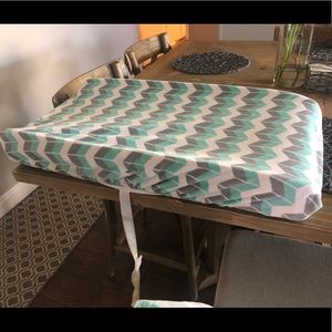 Changing pad with cover and crib skirt